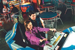 a brother and sister duo enjoying interactive games at the Skylon Fun Centre