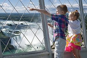 Two small kids enjoying the view from the observation deck at Skylon Tower