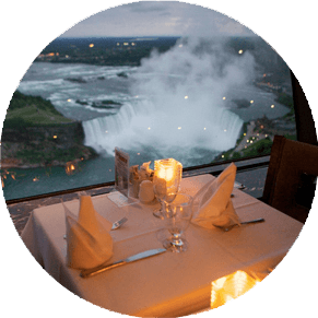 Close-up of a dining room table lit up by candles in the Skylon Tower Revolving Restaurant