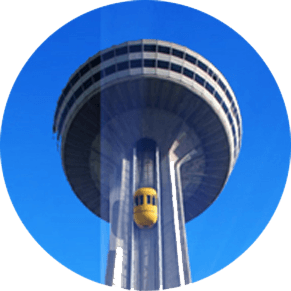 A close up from the ground of the skylon tower elevator almost at the top of the tower.