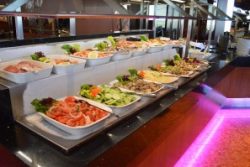 A full view of one of our Skylon Tower buffet table filled with delicious food in our Revolving Restaurant