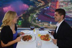 couple on a date at skylon tower with a view of niagara falls