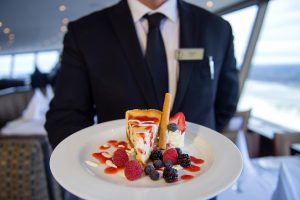 waiter holding dessert plate