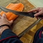 Chef preparing Salmon for the Revolving Dining Room